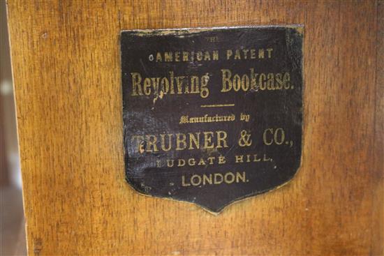 A revolving bookcase by Trubner & Co, H.118cm